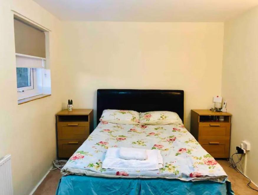 1 dormitorio con 1 cama y 2 mesitas de noche en Private room 4-5 minutes drive to Luton Airport en Luton