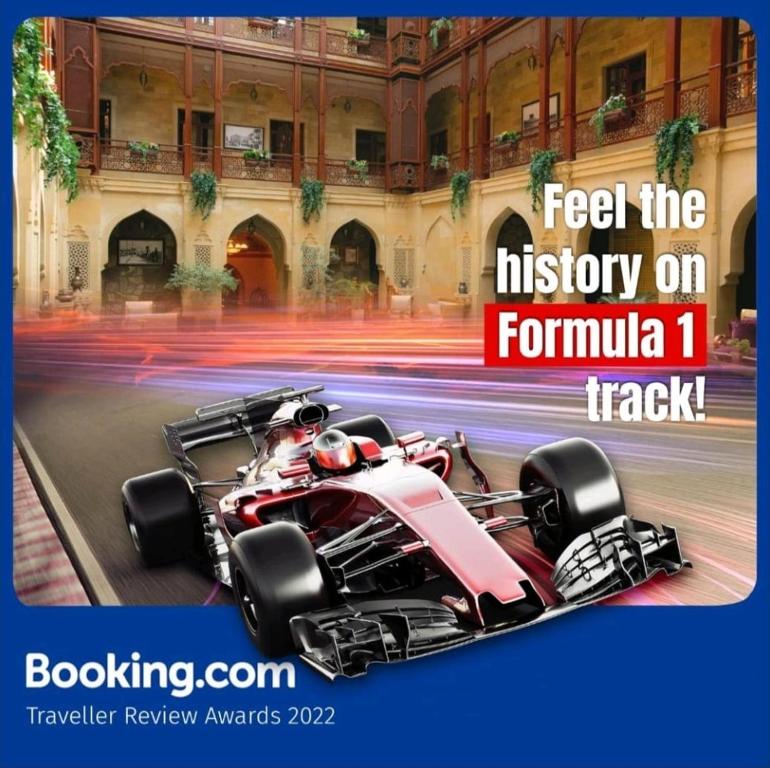 a poster of a formula car on a street at Compleks Hostel of Nizami street in Baku