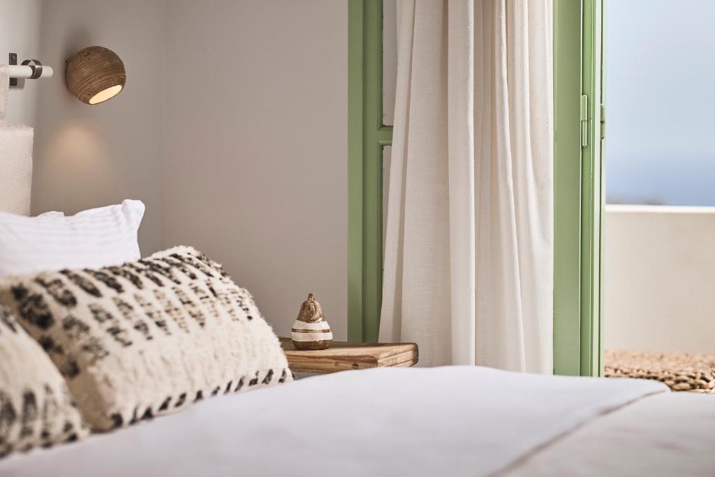 Łóżko lub łóżka w pokoju w obiekcie Antamoma Suites