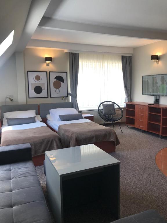 Posteľ alebo postele v izbe v ubytovaní Pokoje Amber