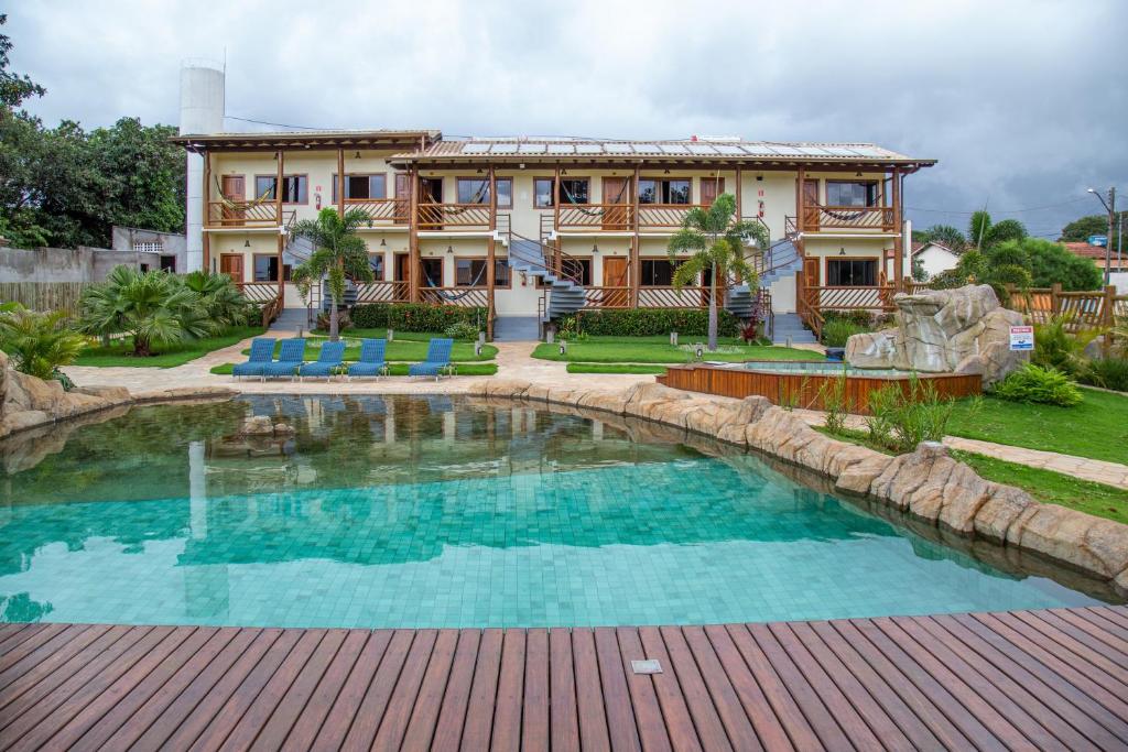 a house with a swimming pool in front of a house at Pousada dos Guias in Alto Paraíso de Goiás