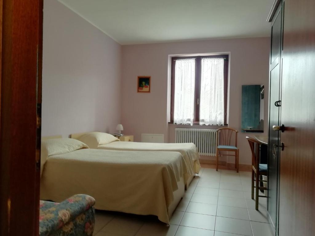 Postel nebo postele na pokoji v ubytování Albergo Breglia