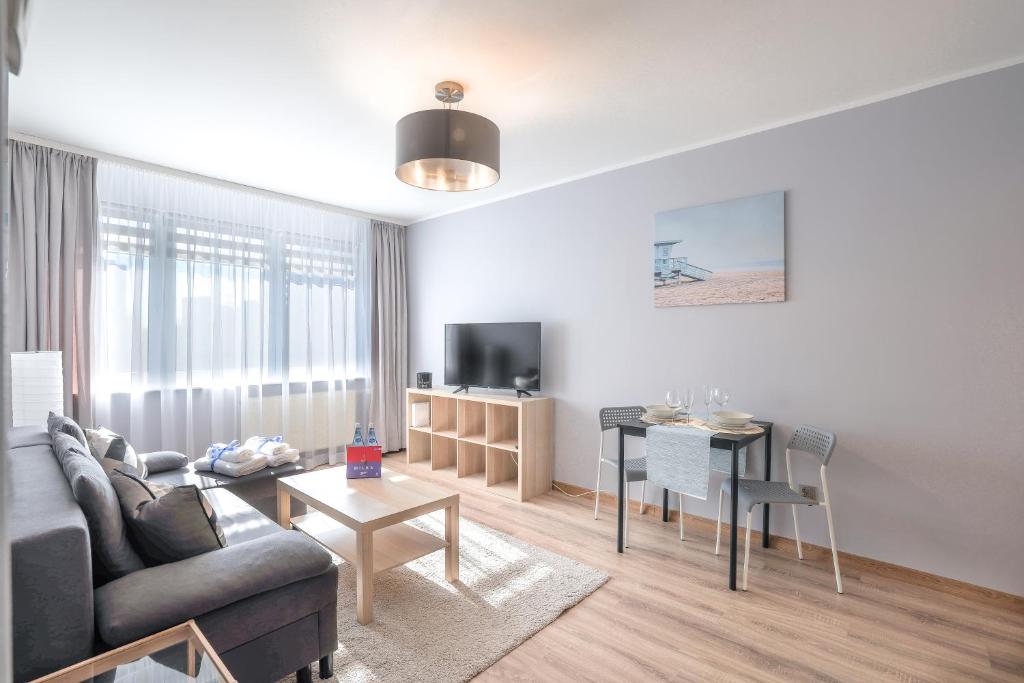 a living room with a couch and a table at AP Apartments Kołobrzeska in Gdańsk