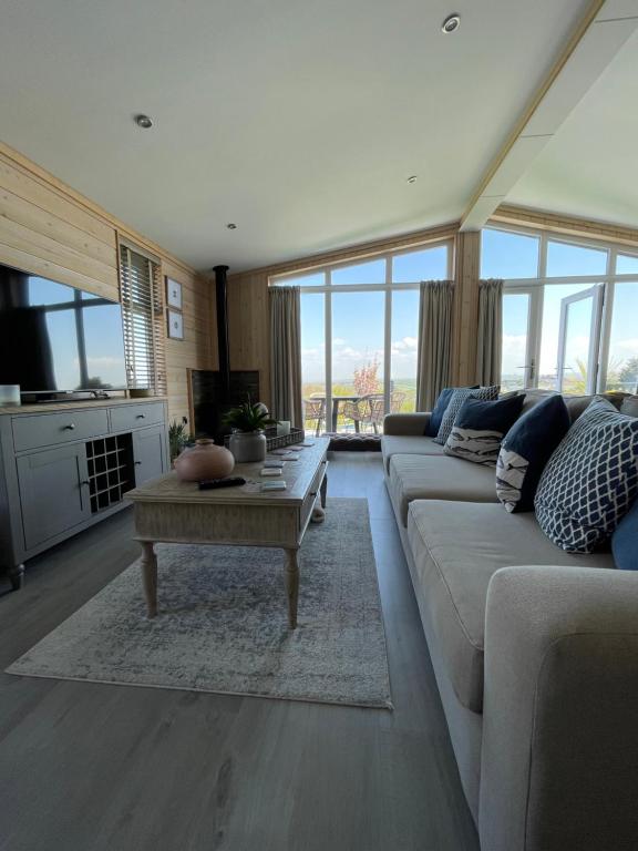 a living room with a couch and a coffee table at 7 Piran View, Padstow in Padstow
