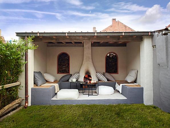 a living room with a couch and a fireplace at 3 Kings in Bruges