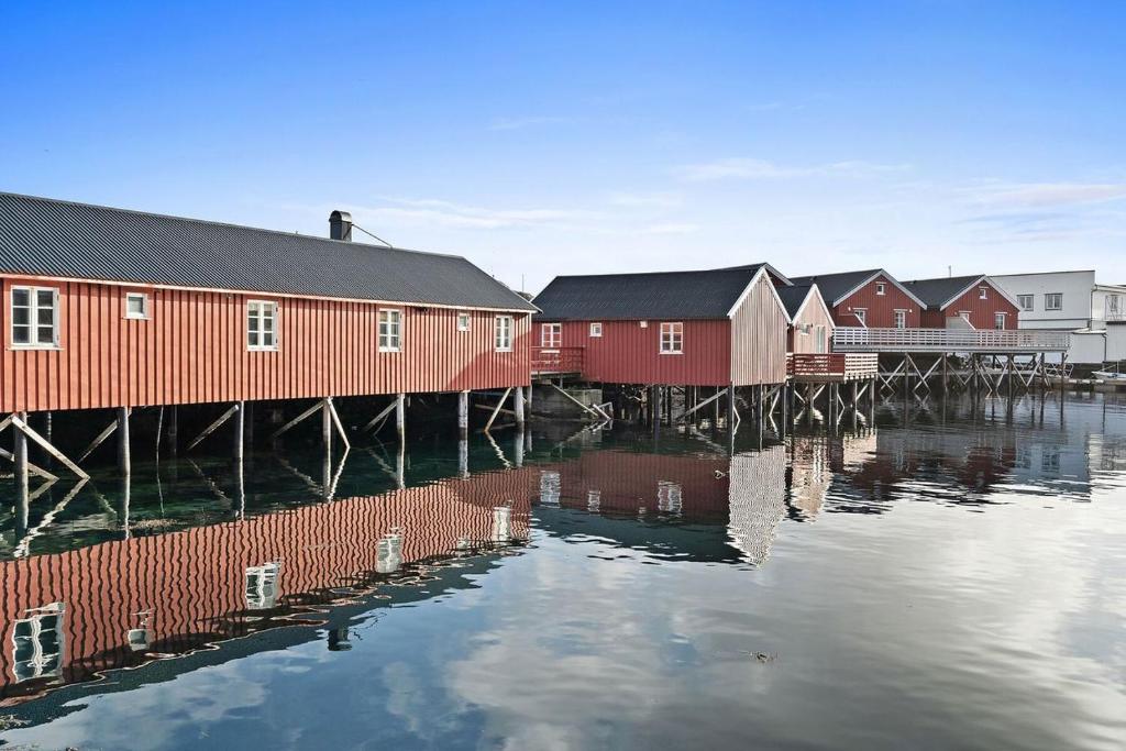 a row of houses next to a body of water at Fishermans cabin in Lofoten, Stamsund in Stamsund