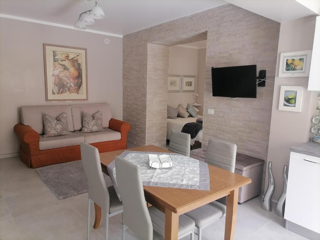 a dining room and living room with a table and chairs at SoleLuna in Santa Elisabetta