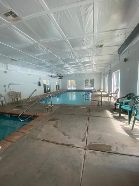 a large swimming pool in a building with a pool at Pinewoods Resort and RV Park in Duck Creek Village