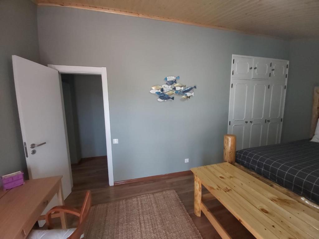 a bedroom with a bed and a wooden table at Tree House in Setúbal