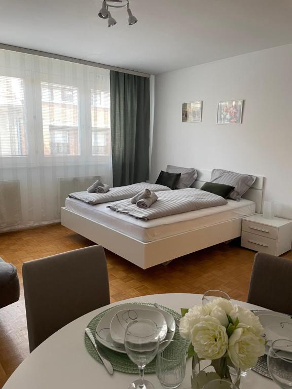 Schlafzimmer mit einem Bett und einem Tisch mit Stühlen in der Unterkunft Apartment Green - Grey in Ljubljana