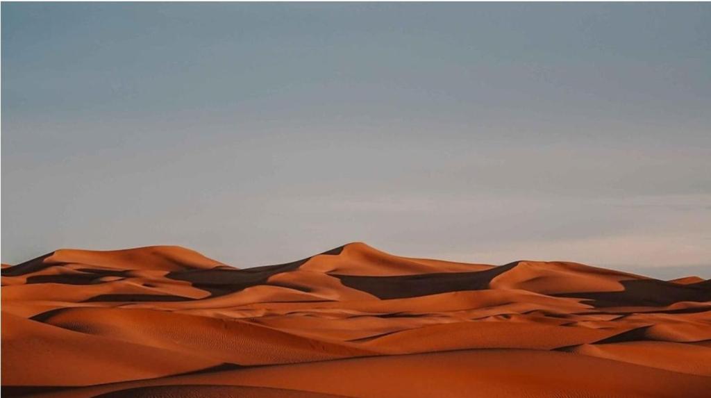 a sand dune in the middle of a desert at Chegaga desert Trips camp in Mhamid