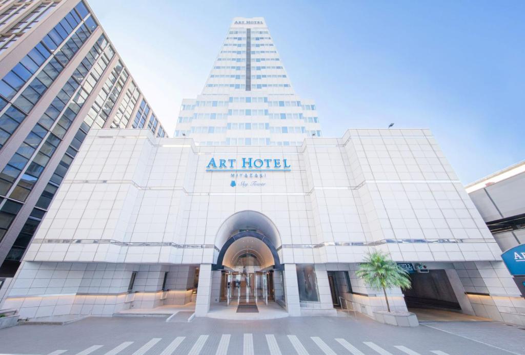 an art hotel with a tall building in the background at ART HOTEL Miyazaki Sky Tower in Miyazaki