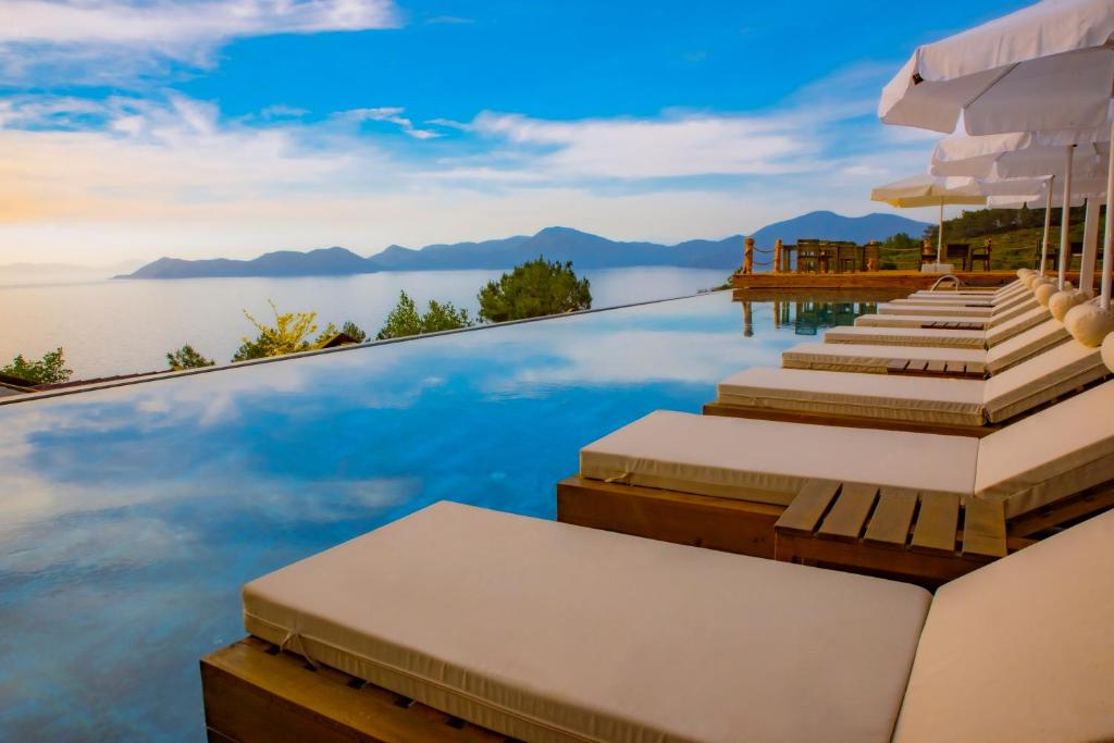 a pool with a view of the water and mountains at Vista Del Amor Faralya in Fethiye