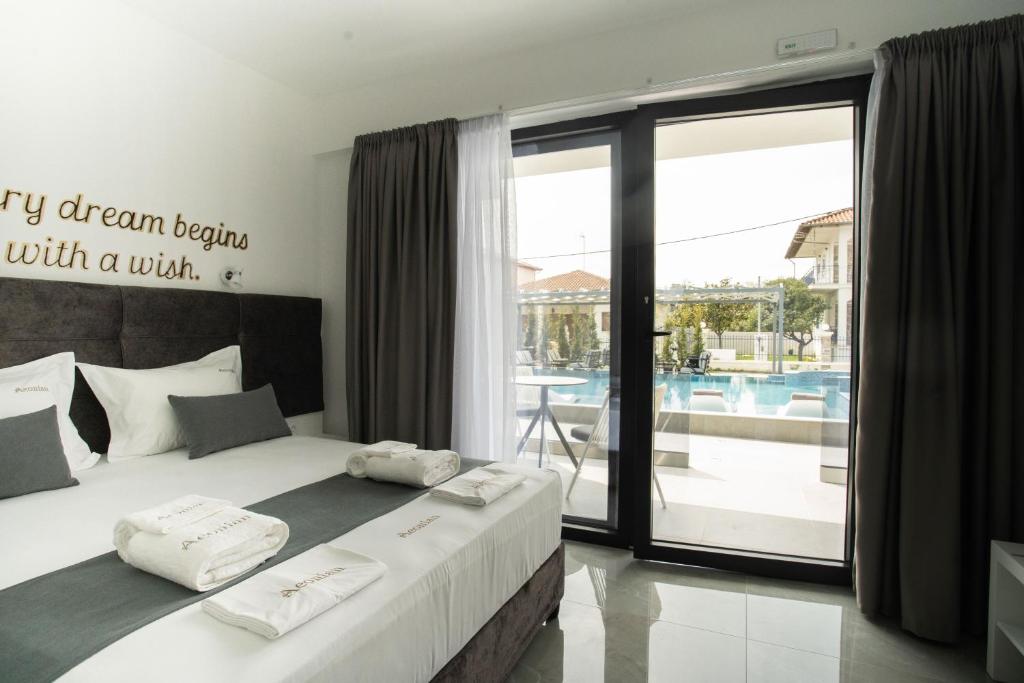 a bedroom with a bed with a view of a pool at Aeonian Luxury Suites Asprovalta, Adults Only & Kids 12 Plus in Asprovalta