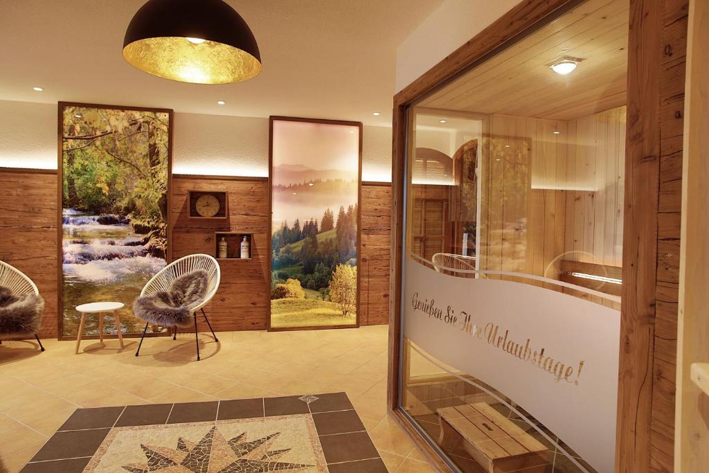 a lobby of a building with chairs and a window at Feriengut Waldblick in Sankt Oswald