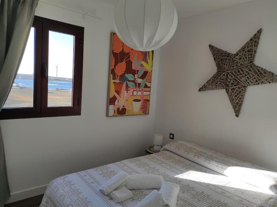 Postel nebo postele na pokoji v ubytování ATALAYA SUNSET terrazza panoramica privata con vista al mare