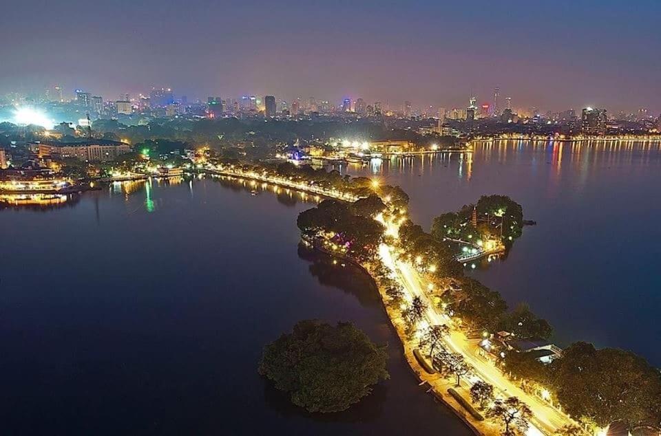 an aerial view of a city at night at Joye Hotel in Hanoi