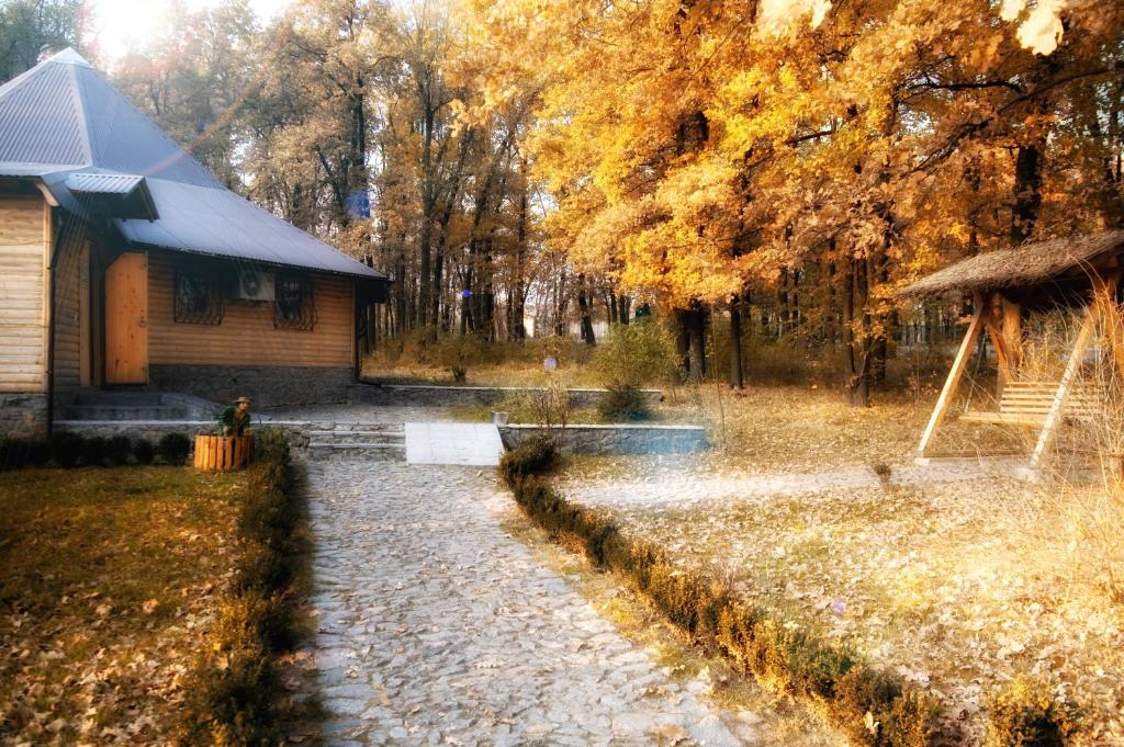 a yard with a house and a tree at Kolyba Complex in Uman