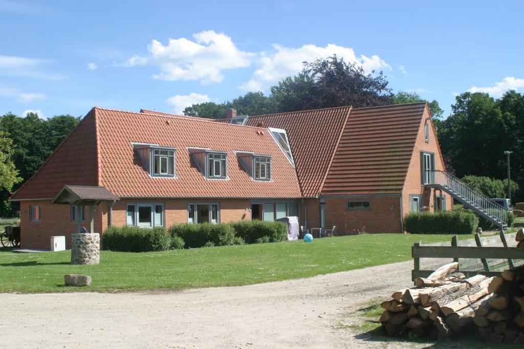 una casa de ladrillo con una escalera delante de ella en Hof Viehbrook en Hollenbek