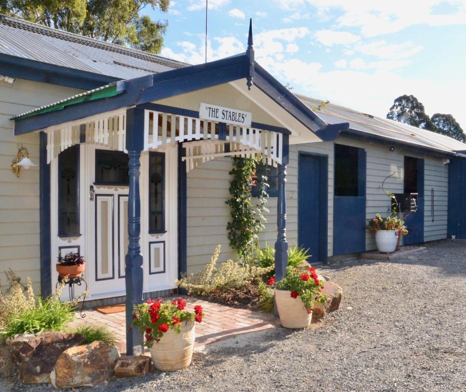 a tiny house with a sign that reads the survey at The stables in Wandin North