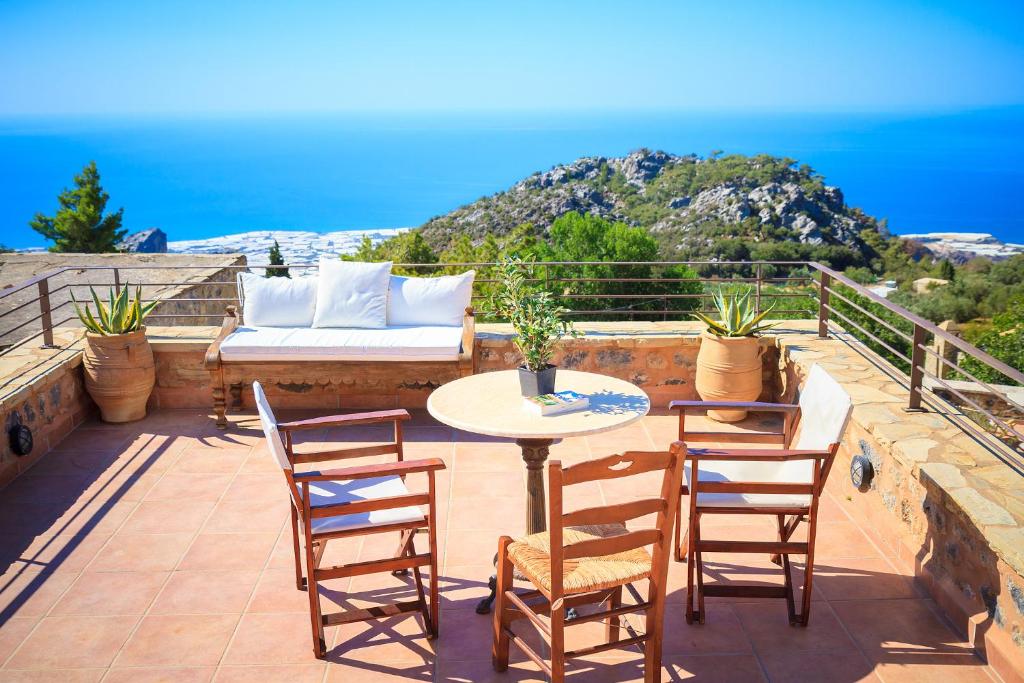 a patio with a table and chairs and a couch at PERSEPHONE ART COUNTRY HOUSE in Ierapetra
