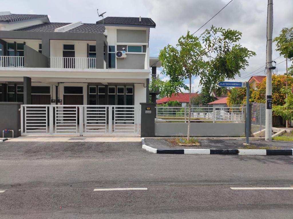 an empty street in front of a house at Juliana Homestay in Jitra
