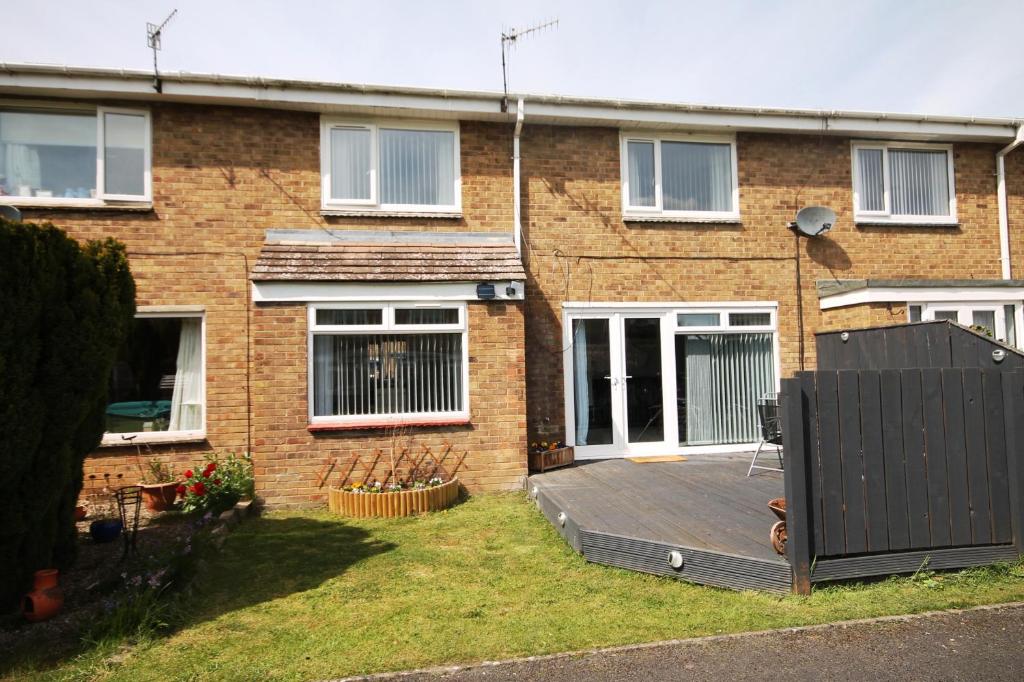 a brick house with a deck in the yard at Home From Home in Stanhope