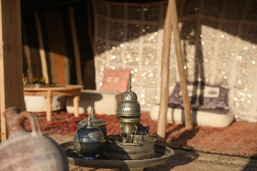 a room with a table with a tea pot on it at Emeraude Camp Agafay in El Karia