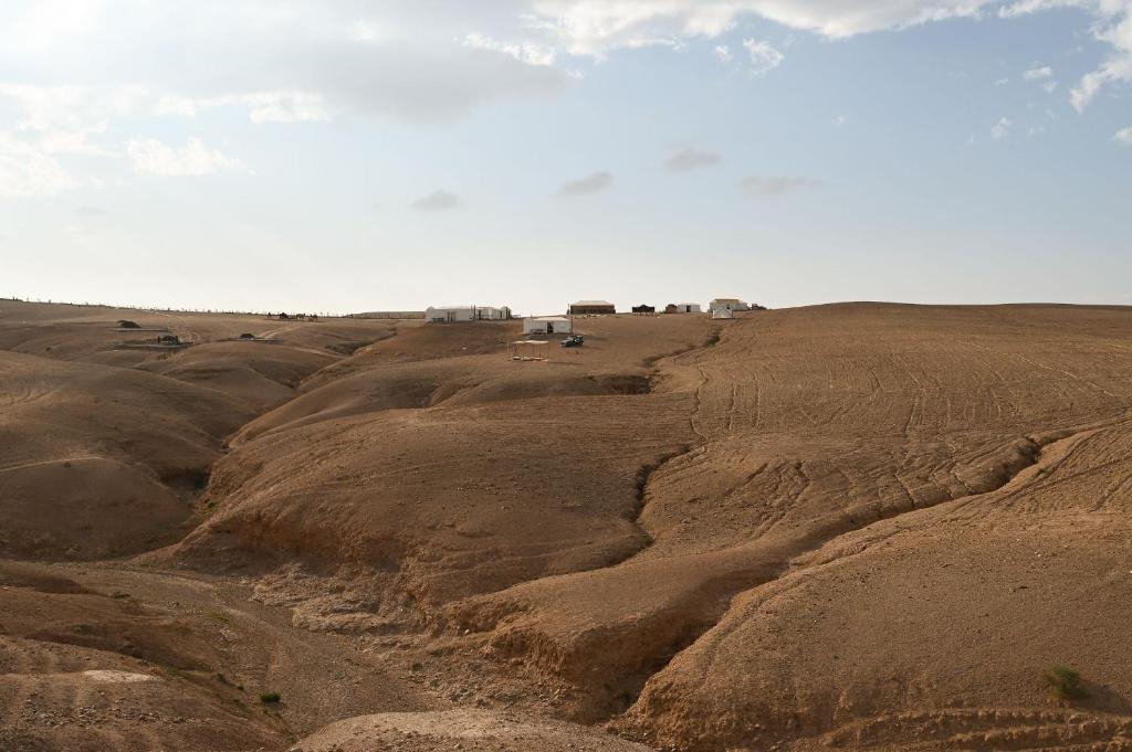 an open field with brown dirt in the desert at Emeraude Camp Agafay in El Karia