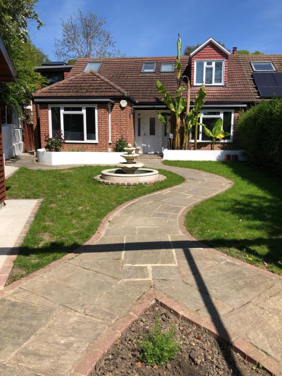 a house with a walkway in front of a yard at Self contained ensuite double bedroom with own entrance FREE OFF STREET PARKING in London