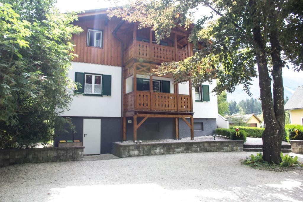 a house with a deck on the side of it at Villa Silvanus in Ebensee