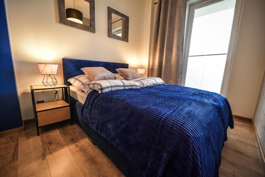 Posteľ alebo postele v izbe v ubytovaní Apartament Komfort 17