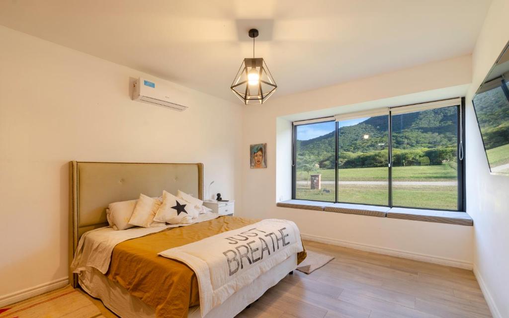 a bedroom with a bed and a large window at Naturaleza y tranquilidad in Salta