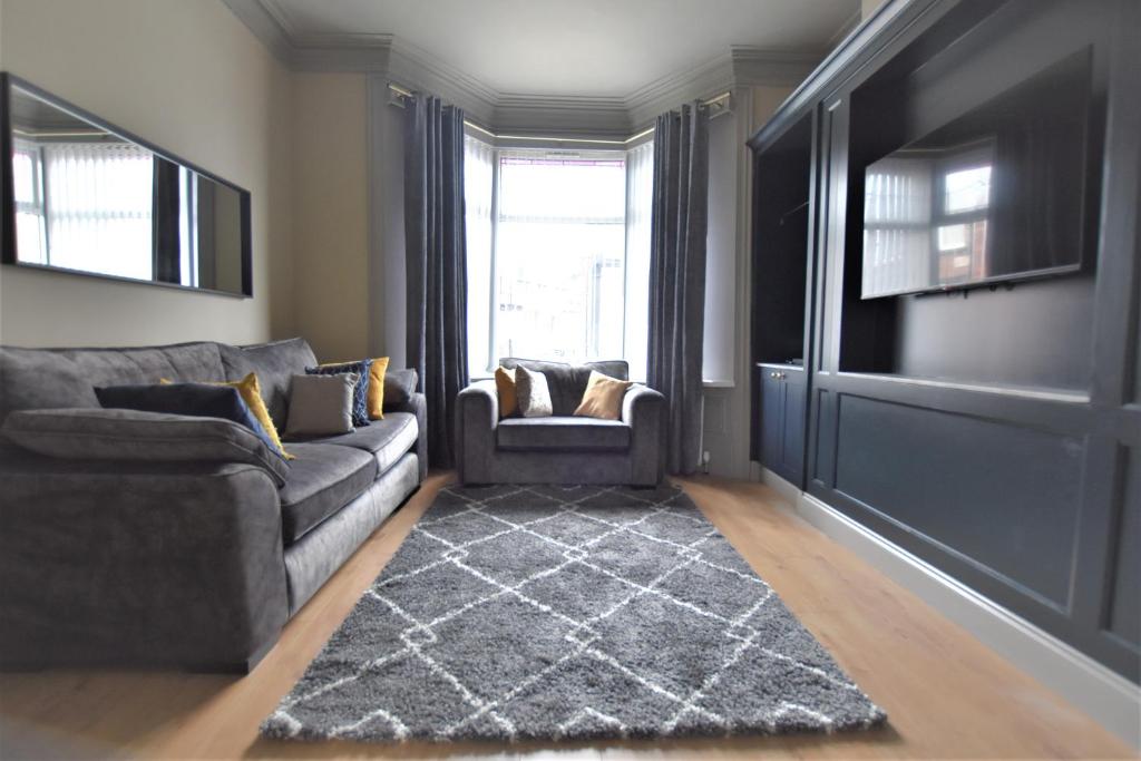 uma sala de estar com um sofá e uma janela em Dwell Living - Central Comfortable Cosy 3 bedroom home em Pallion