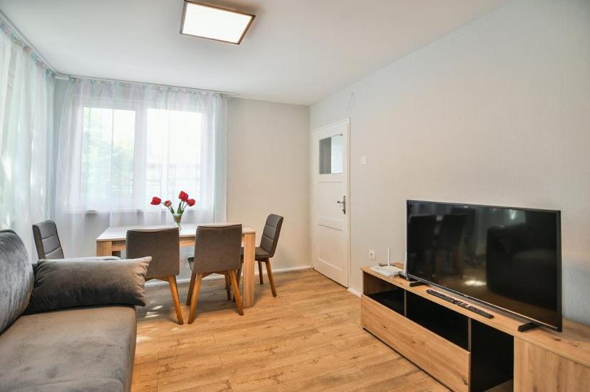 a living room with a couch and a television and a table at House Stavrevi in Varna City