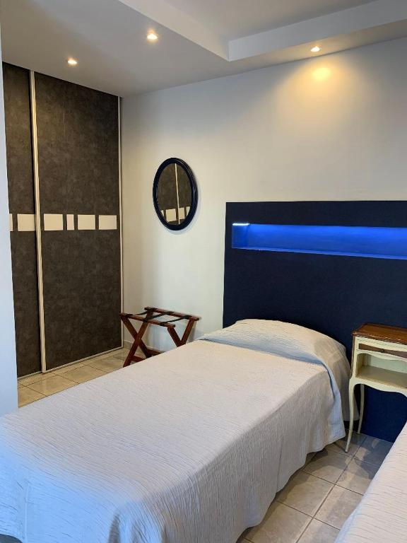 a bedroom with two beds and a blue window at Sole e Mare in Galeria