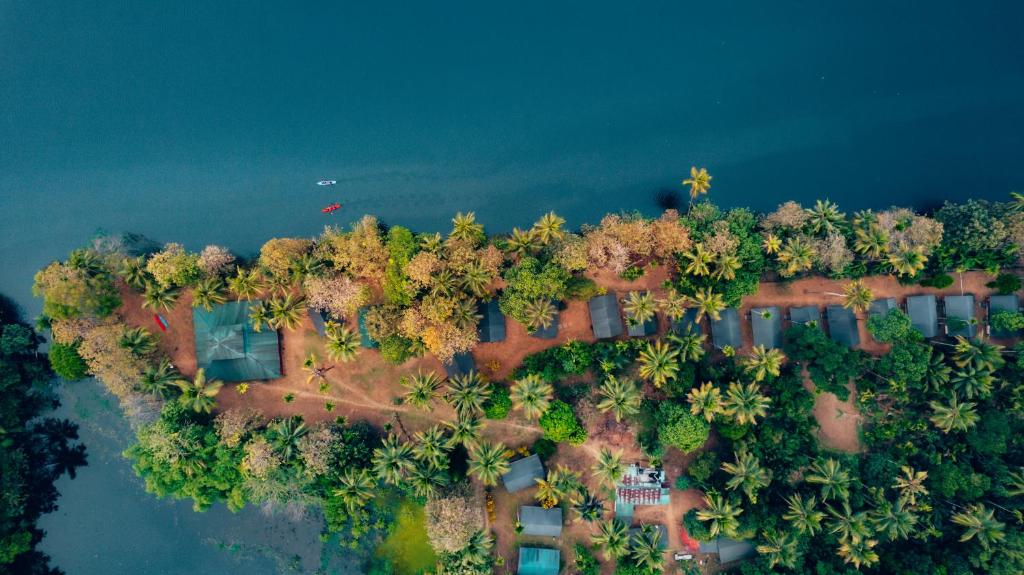 an aerial view of an island in the water at Amritara Riverside Luxury Tents in Thattakād