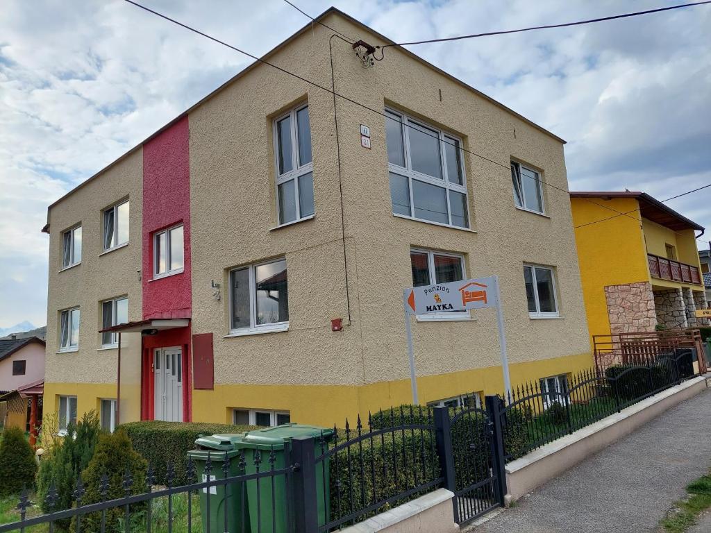 a building with colorful paint on the side of it at Penzion MAYKA in Hrabušice