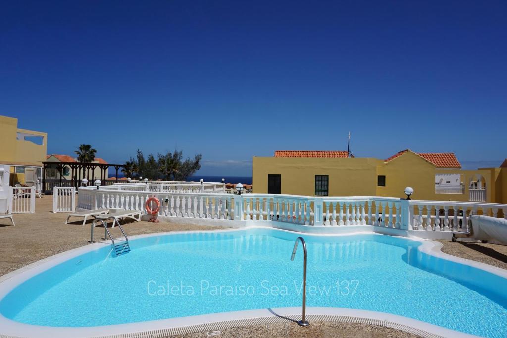 a swimming pool on the balcony of a villa at Caleta Paraiso Sea View 137 in Costa de Antigua