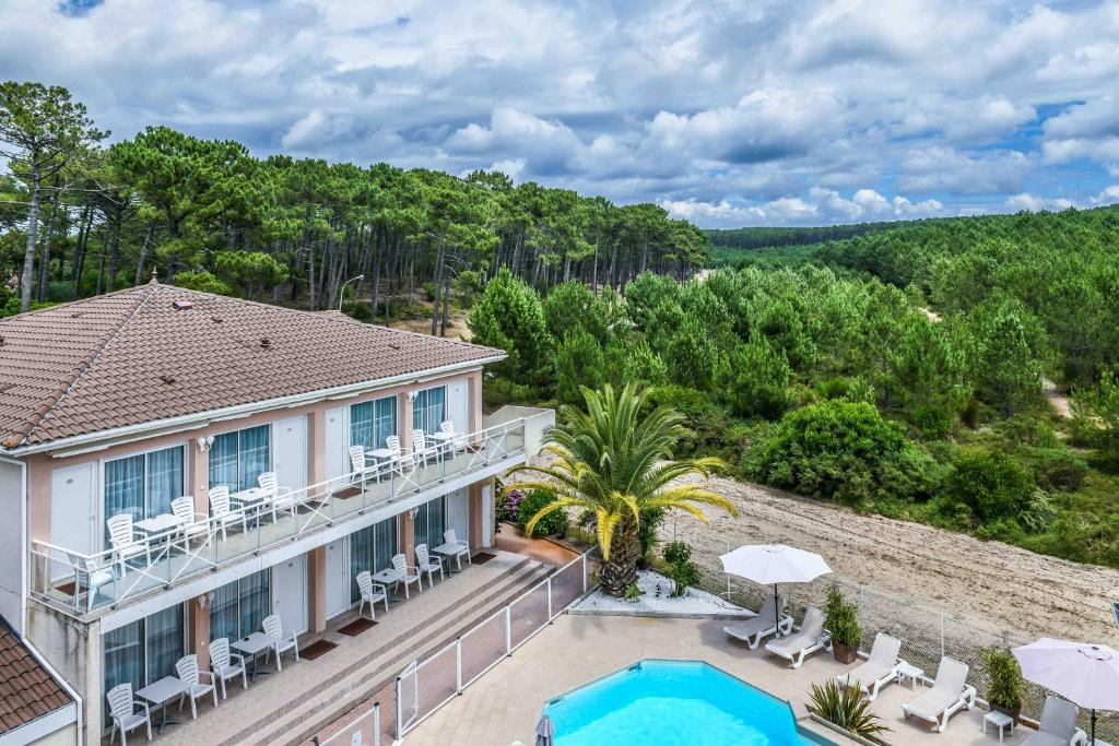 an aerial view of a villa with a swimming pool and a resort at Hôtel Restaurant La Forestière in Biscarrosse-Plage