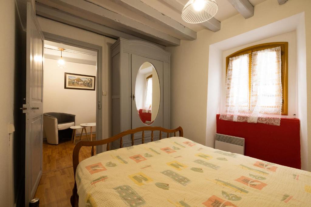 sypialnia z łóżkiem, stołem i oknem w obiekcie Maison a la Frontière Espagnole w mieście Arnéguy
