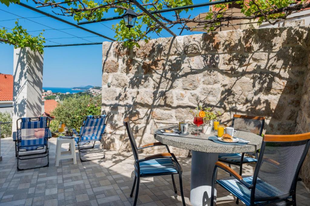 a table and chairs on a patio with a view at Apartment Ruzica in Dubrovnik