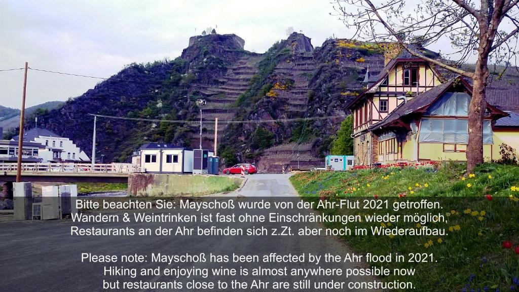 a sign in front of a mountain with a house at Am Bungert in Mayschoß