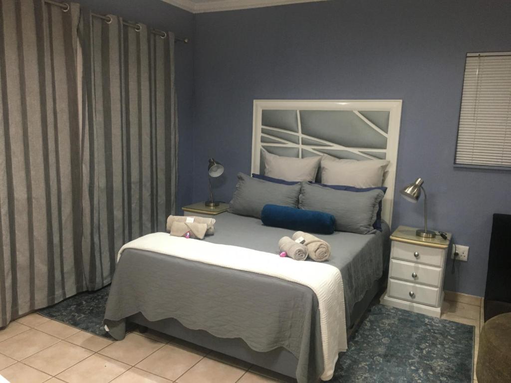 a bedroom with a bed with stuffed animals on it at Rest Assured in Roodepoort