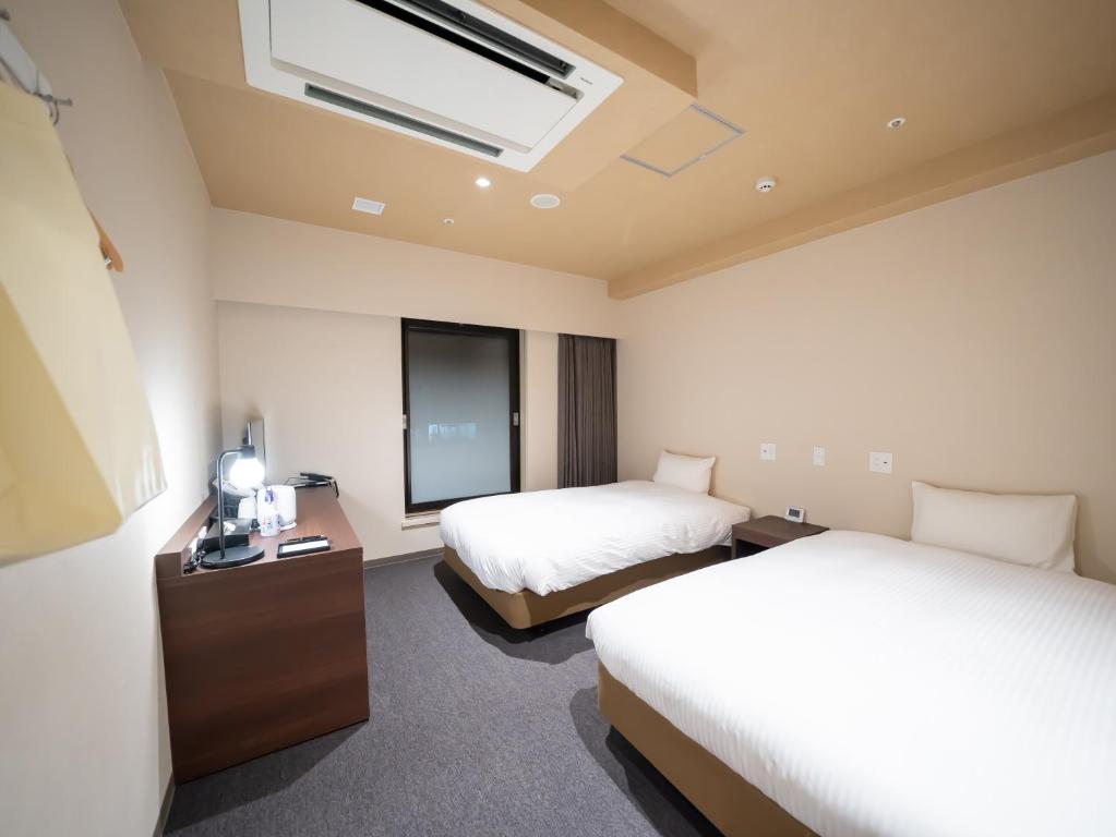 Postel nebo postele na pokoji v ubytování Shinsaibashi ARTY Inn