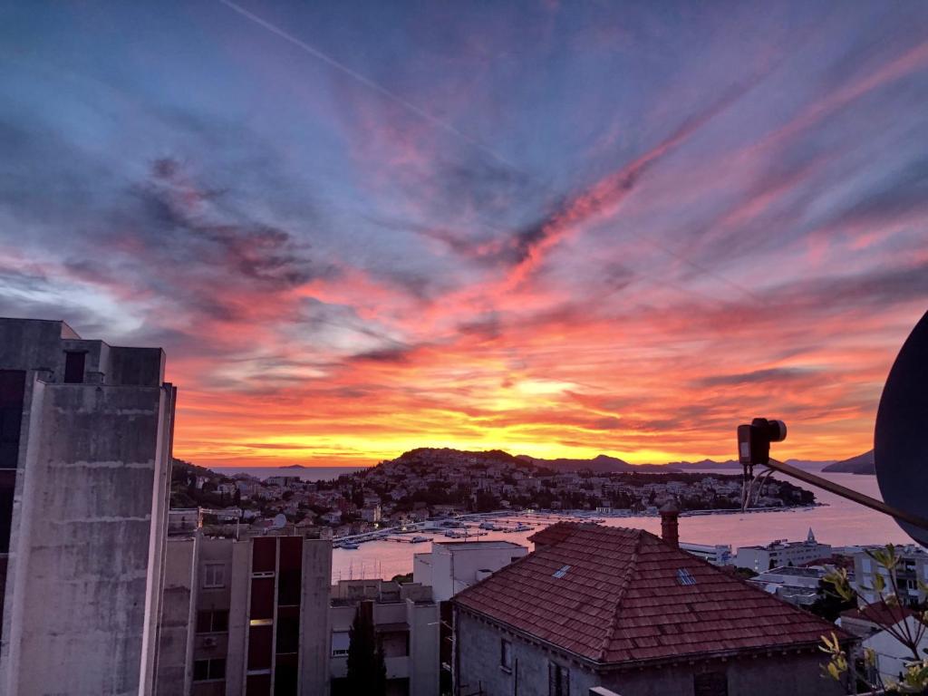 a view of a city with a sunset at Apartments Adaleta in Dubrovnik