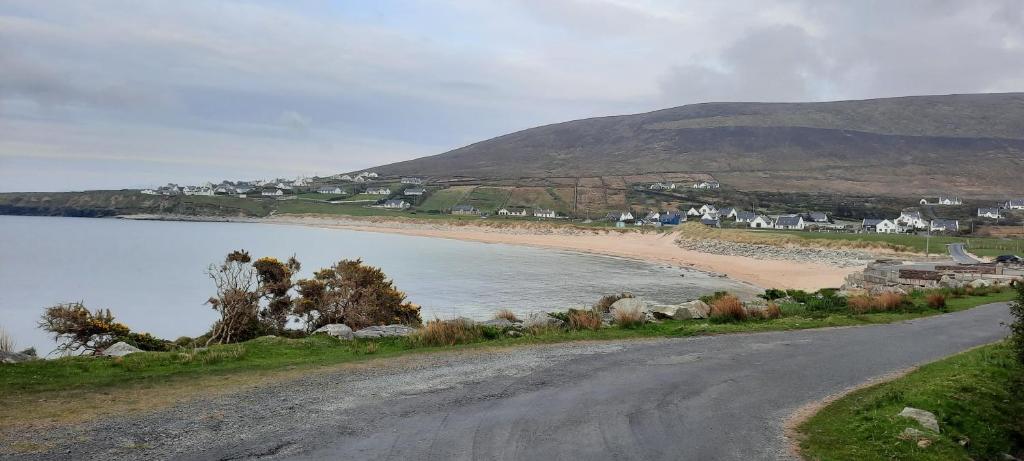 a dirt road next to a beach with houses at Creevagh (Room Only) in Keel