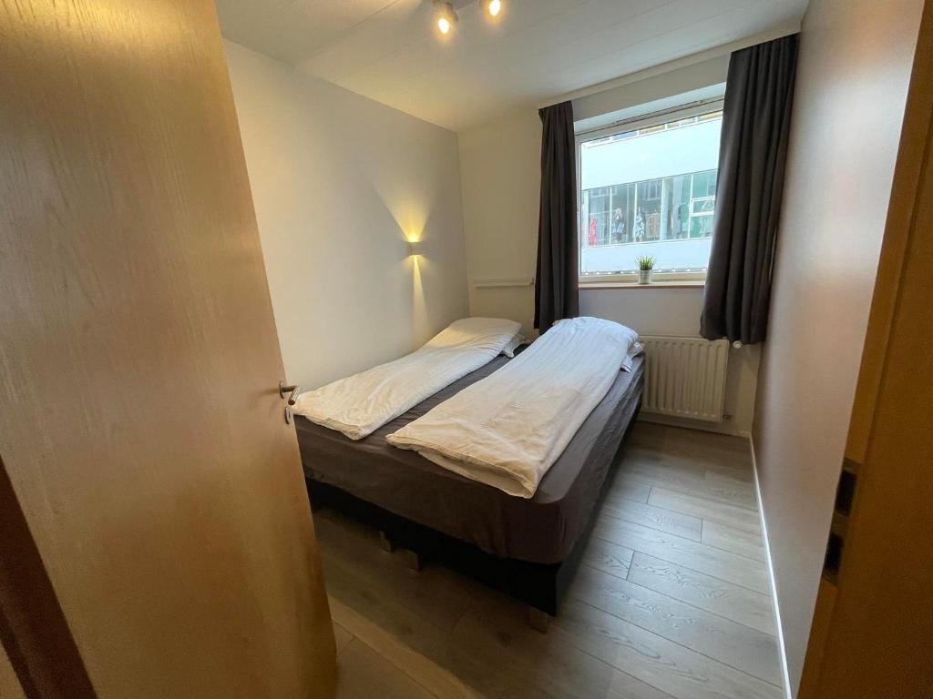 Säng eller sängar i ett rum på Saga Apartments Akureyri