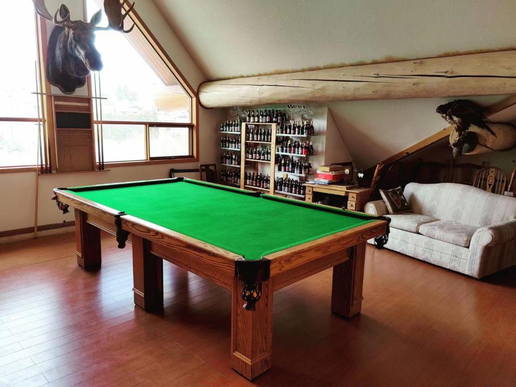 a living room with a pool table in it at Bear's Claw Lodge in Cache Creek