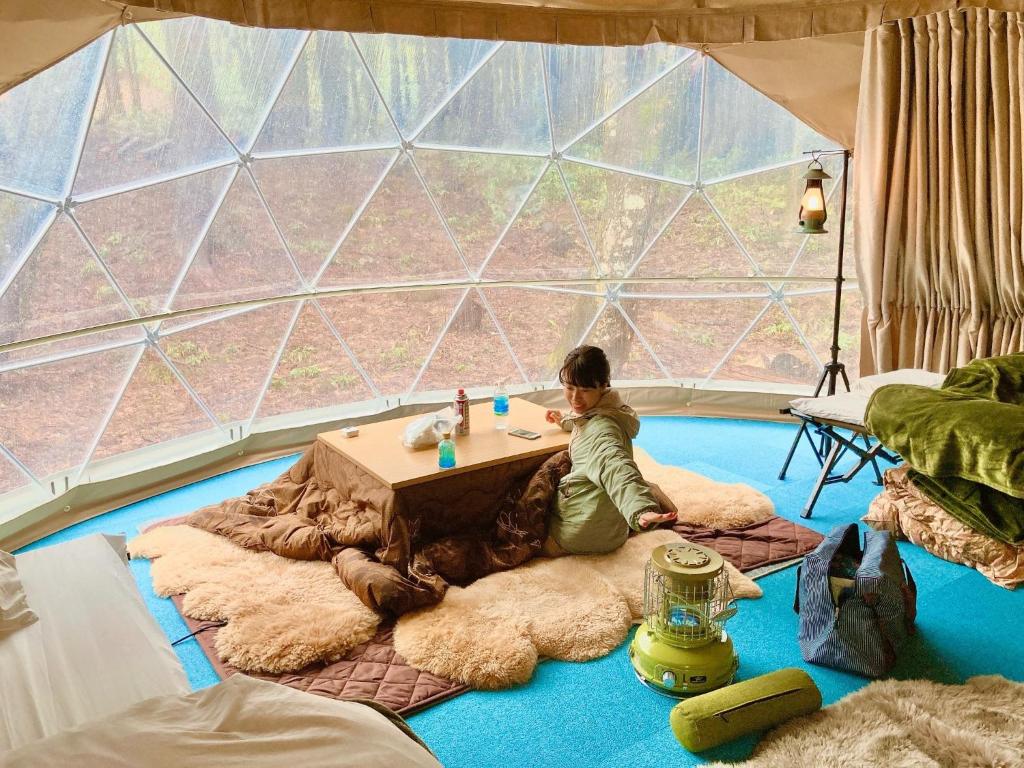 a child sitting at a table in a tent at North Villge Hirugano - Vacation STAY 32983v in Gujo
